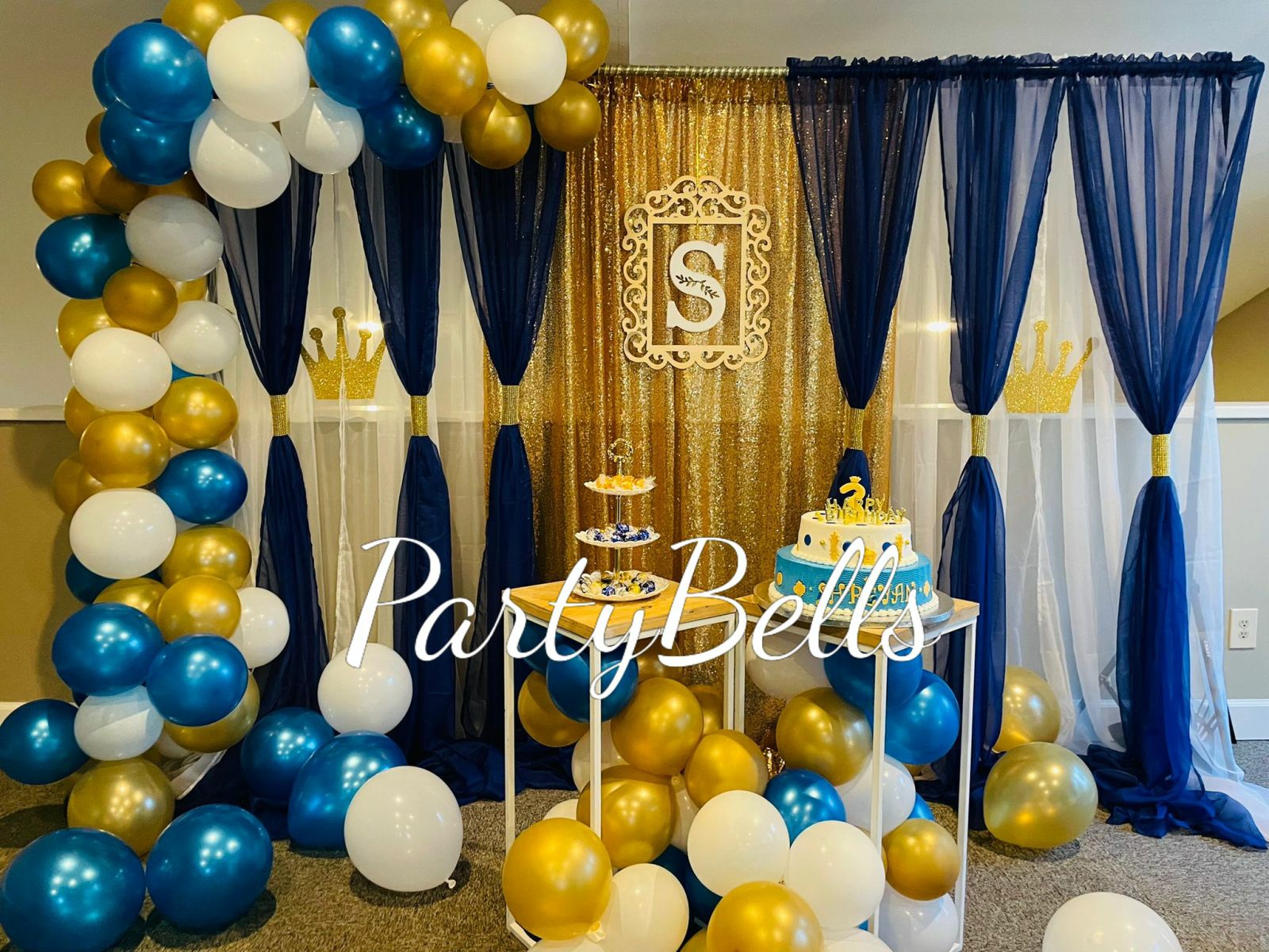 Elegant blue and gold baby shower decor with backdrop and centerpieces